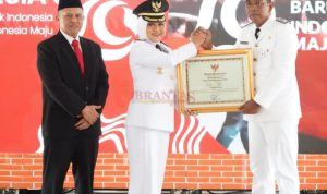 Bupati Ikfina didampingi Sekda Teguh Menyerahkan Penghargaan Lunas Pajak PBB kepada Kades Kalipuro Sugeng Santoso pada upacara HUT Kemerdekaan RI ke 79