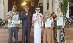 Bupati Mojokerto dr Ikfina Fatmawati didampingi Kepala Disperindag Kabupaten Mojokerto H.M. Iwan Abdillah SH, S.Sos, M.Si, photo bersama Penerima Sertifikat Halal dan Merk Usaha